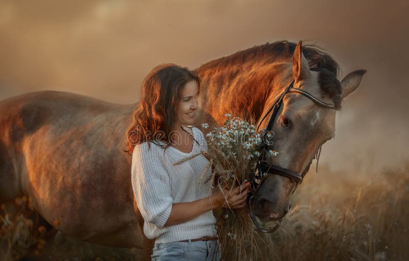 Beautiful  young woman on spanish buckskin horse in rue field