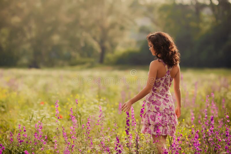 Beautiful young woman in spring flowers outdoors