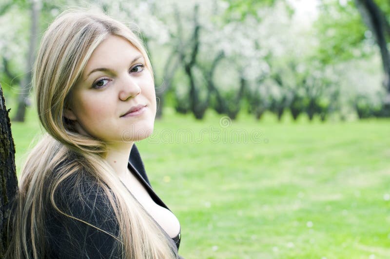 Beautiful young woman in the spring garden