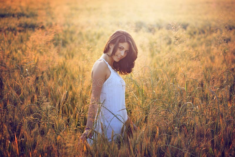 Beautiful young woman in a summer field