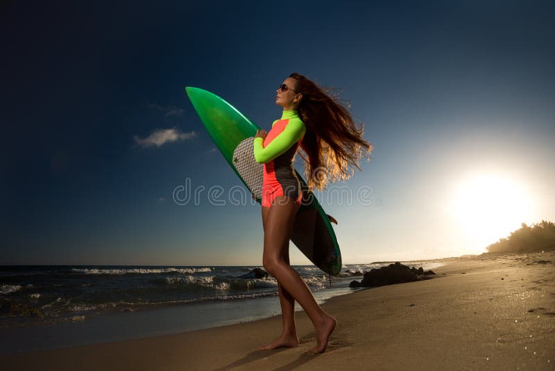 Beautiful young woman surfer