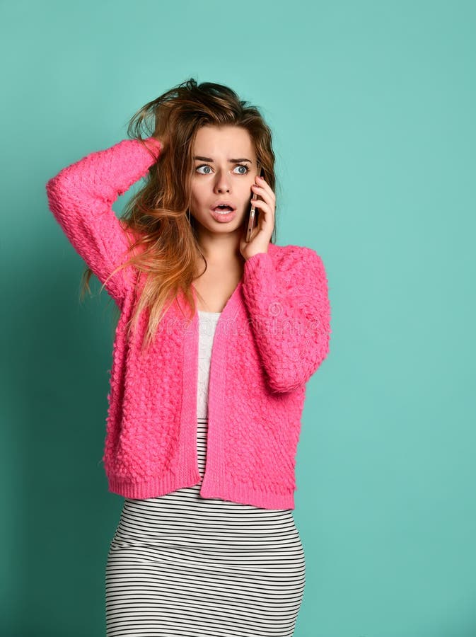 Beautiful young woman talking by mobile phone on light background stock photography Beautiful young woman talking by mobile phone on light background stock photography