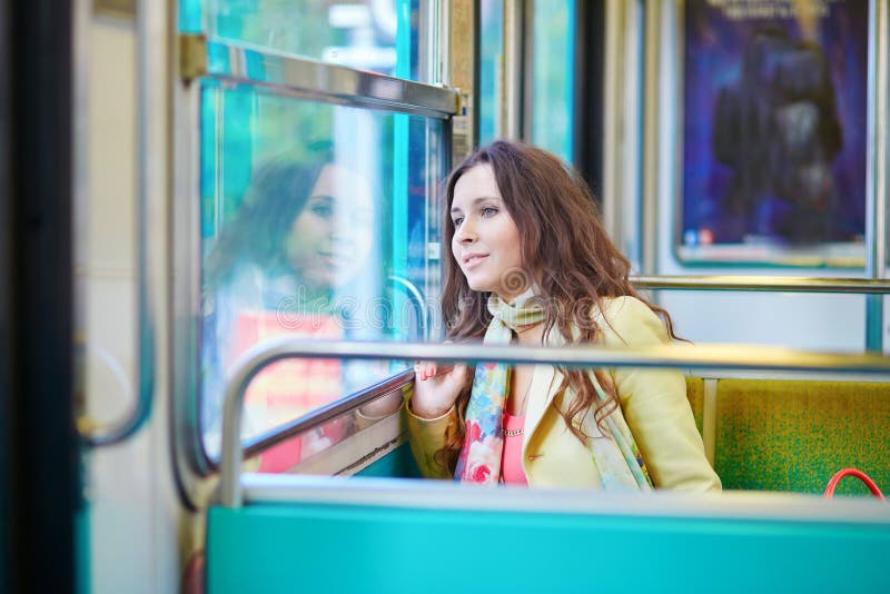 Beautiful young woman travelling in a train of Parisian subway