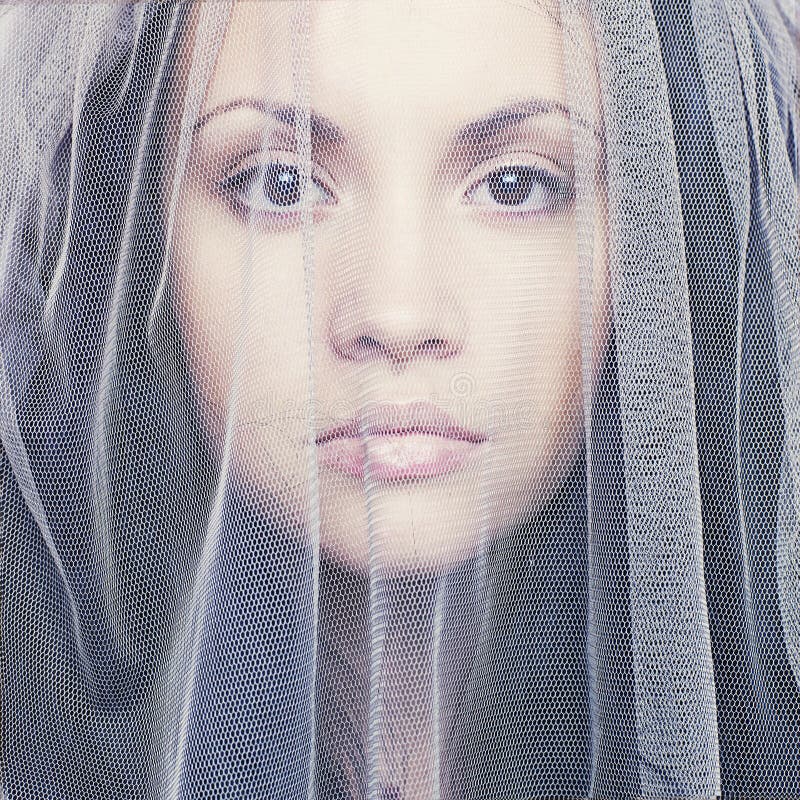 Beautiful young woman under a veil stock photography