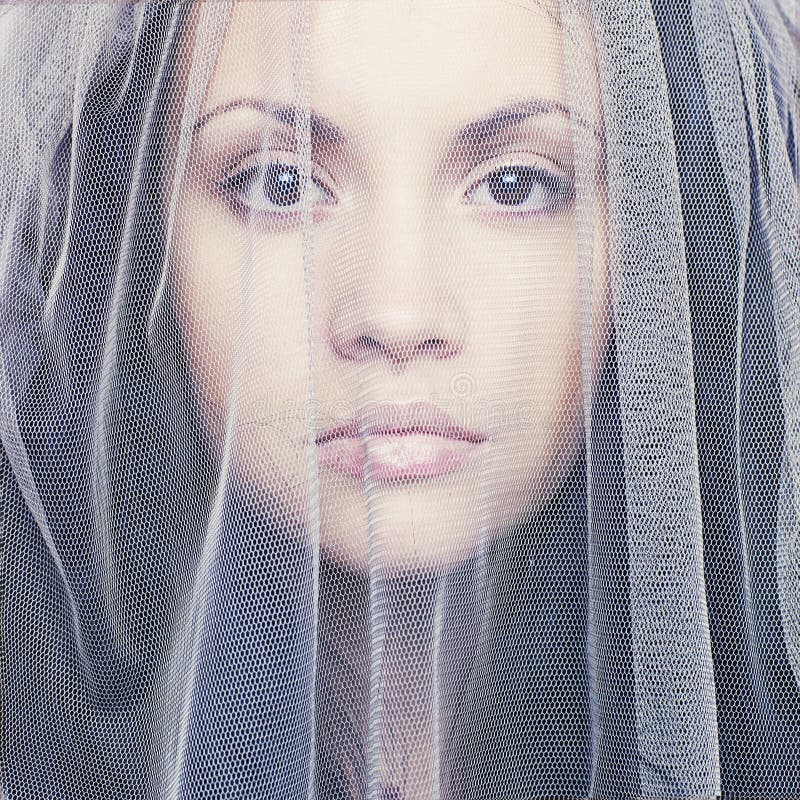 Beautiful young woman under a veil