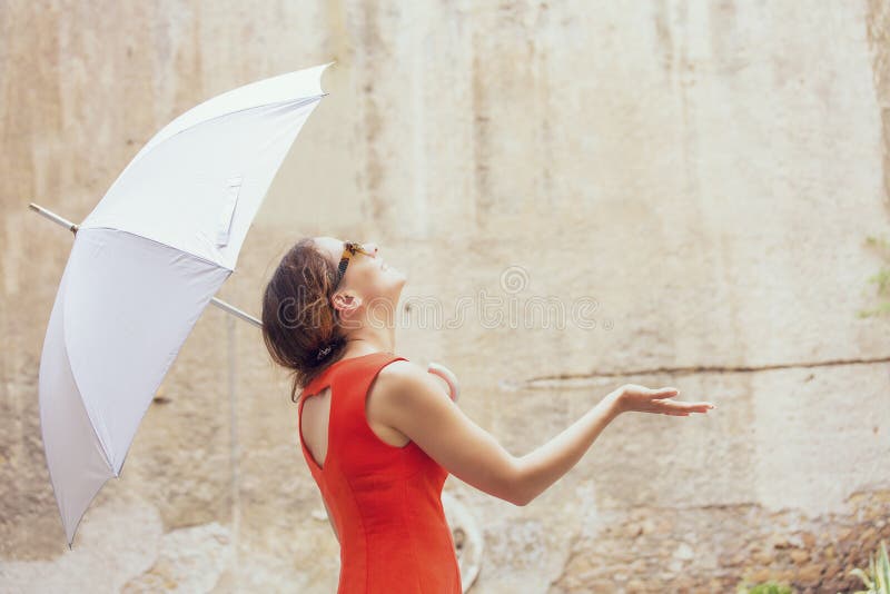 Beautiful young woman under white umbrella royalty free stock photography