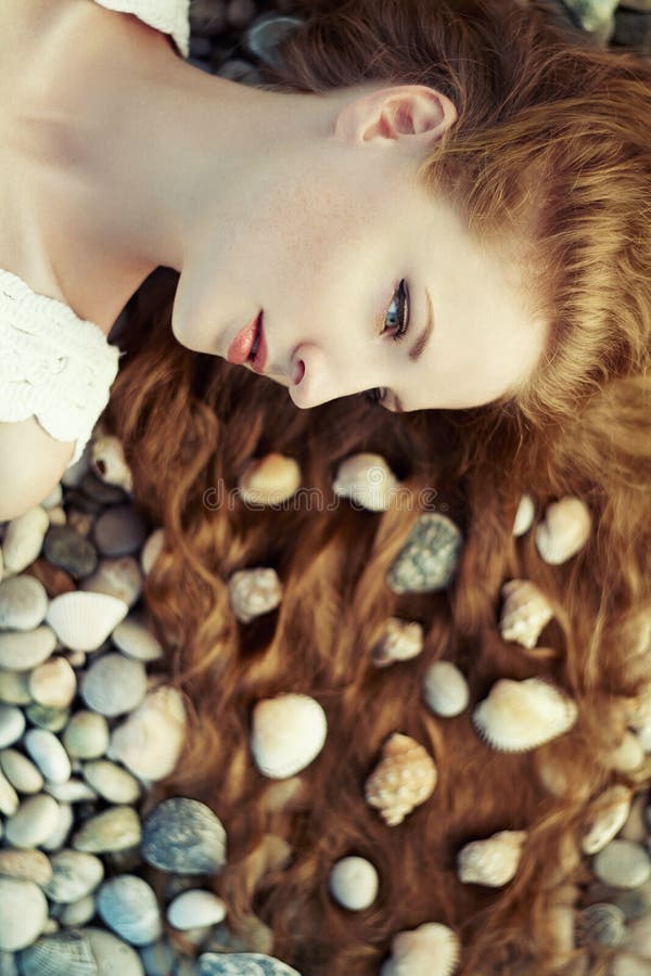 Beautiful young woman with unusual hairstyle on beach royalty free stock photography Beautiful young woman with unusual hairstyle on beach royalty free stock photography