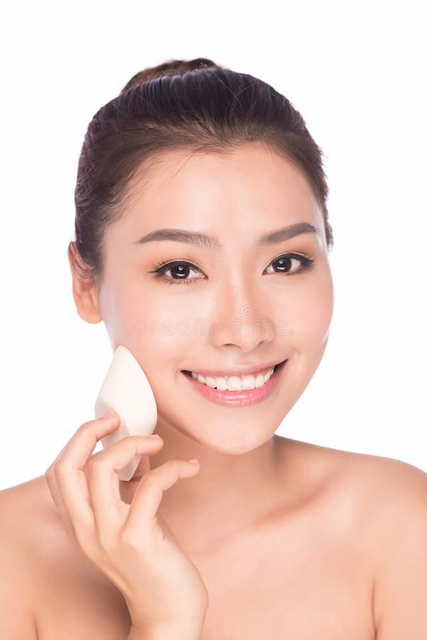 Beautiful young woman using a powder stock images