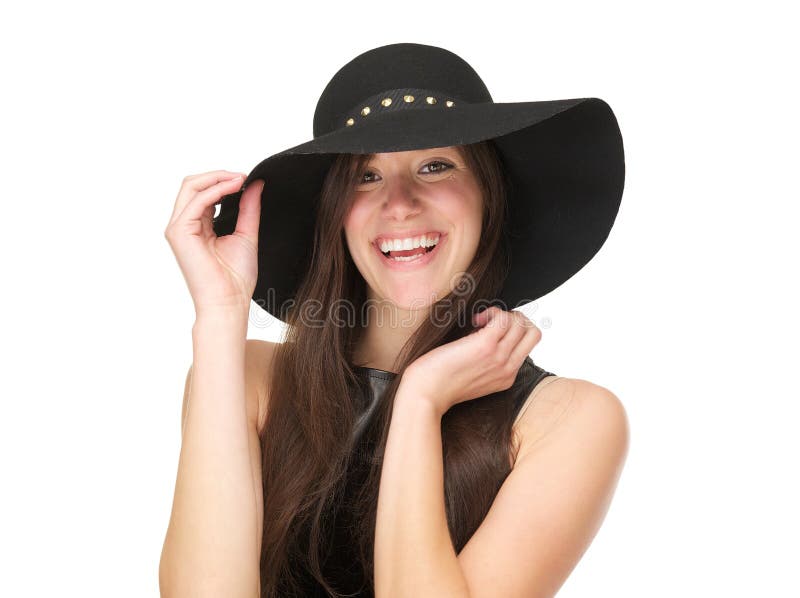 Beautiful young woman wearing black hat and laughing