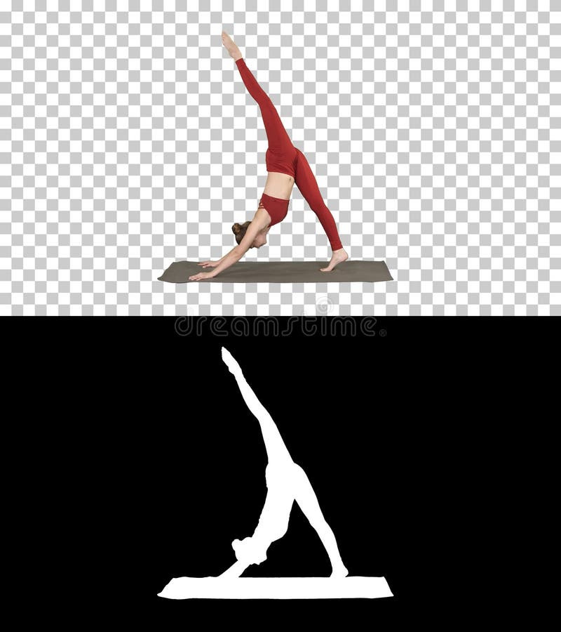 Beautiful young woman wearing red sportswear doing yoga or pilates exercise Standing in variation of Natarajasana, Alpha stock photo Beautiful young woman wearing red sportswear doing yoga or pilates exercise Standing in variation of Natarajasana, Alpha stock photo
