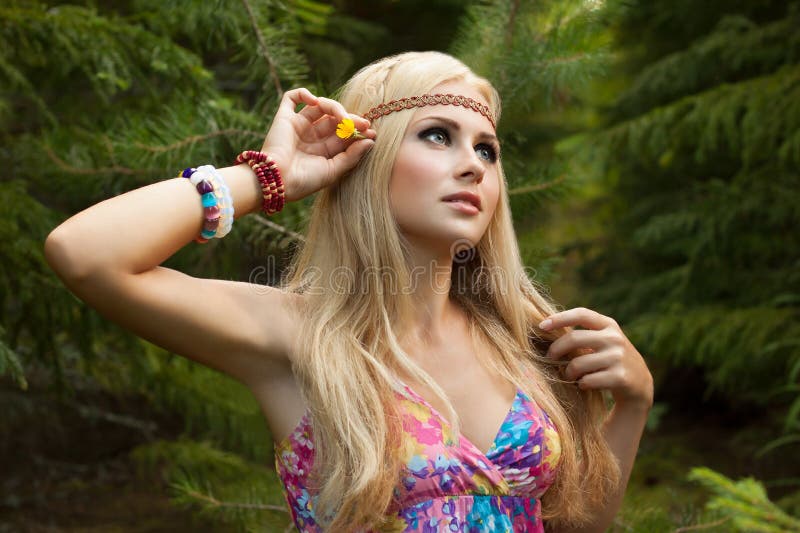 Beautiful young woman in wood decorates hair