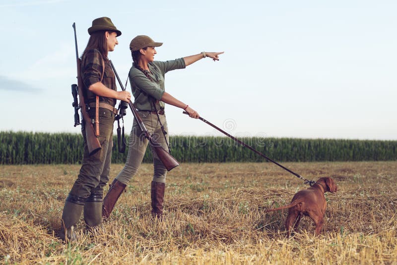 Women hunters with hunting dog.