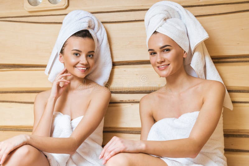 beautiful young women relaxing in sauna and looking