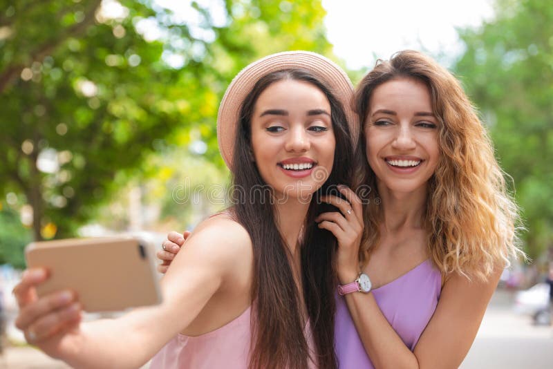 Beautiful Young Women Taking Selfie Outdoors on Sunny Stock Photo ...