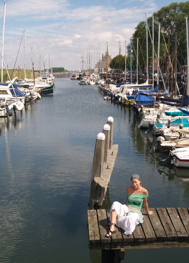 Beautifull girl and Yachts docked in Veere, Zeeland.
