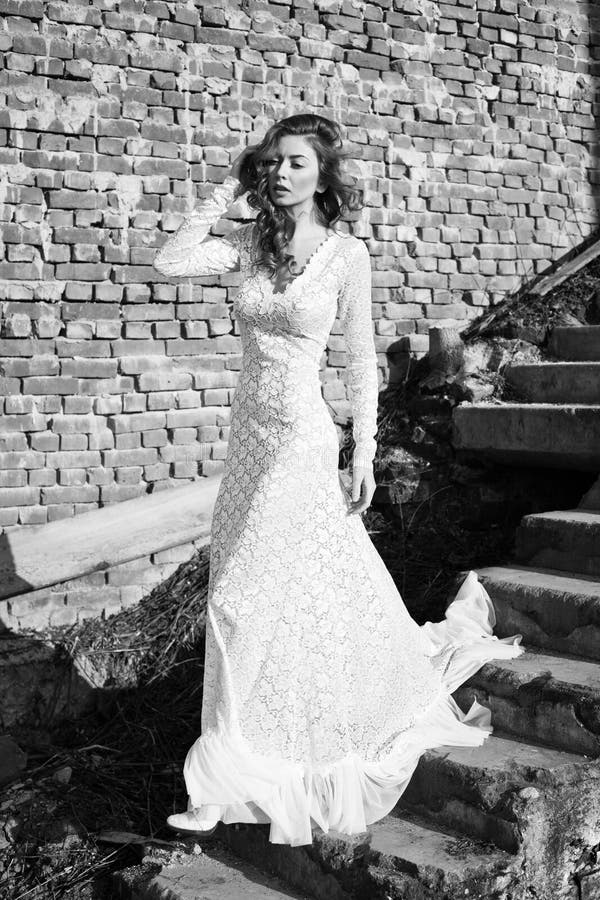 Beautifull woman in white dress posing outdoor