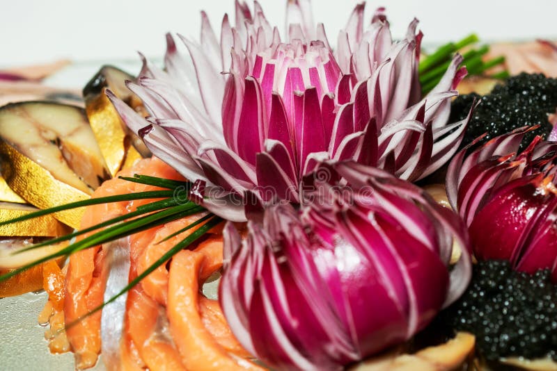 Beautifully Chopped Blue Flowershaped Onion on a Tray Stock Photo