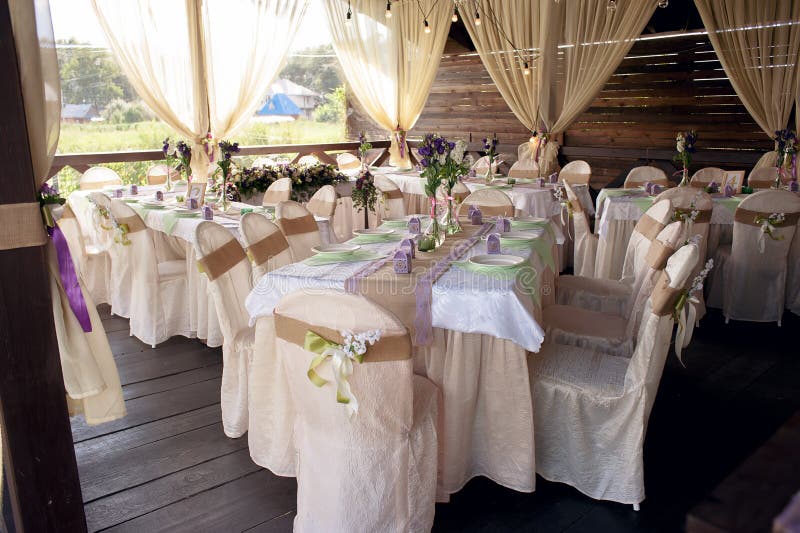 beautifully decorated table for the wedding ceremony served banquet table decorated with fresh flowers in the open air