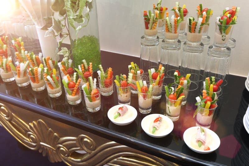 Beautifully served snacks of fruit, and vegetable salad on a wedding cocktail, meeting and press conference side table. Beautifully served snacks of fruit stock images Beautifully served snacks of fruit, and vegetable salad on a wedding cocktail, meeting and press conference side table. Beautifully served snacks of fruit stock images