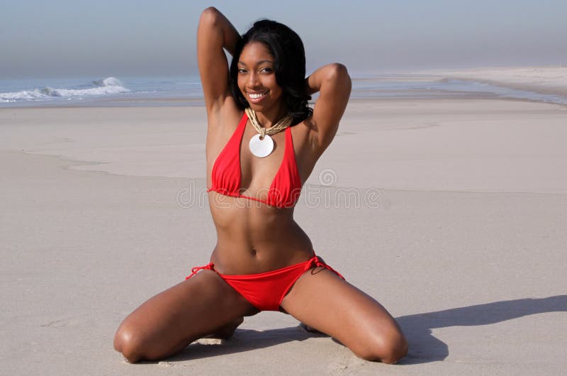 African american woman in bikini posing on a beach. African american woman in bikini posing on a beach