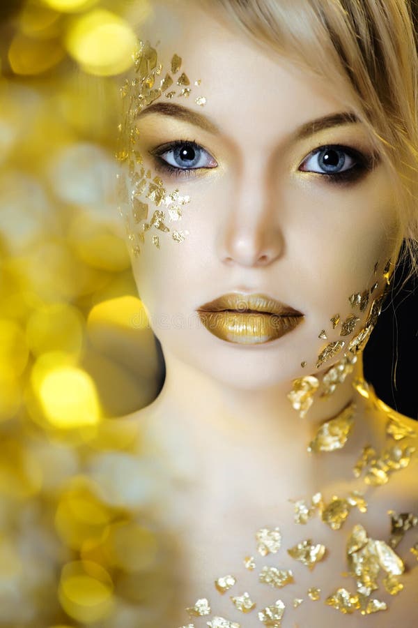 Beauty blond woman with gold creative make up