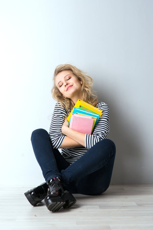 Beauty blonde young woman with books