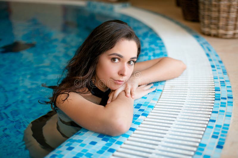 Seductive Woman Relaxing In Indoor Spa Swimming Pool At Hotel Stock