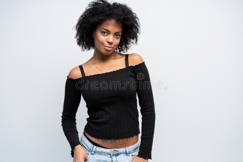 Beauty closeup portrait of young african american girl with afro. Girl looking at camera.