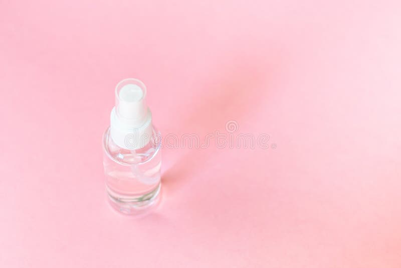 Beauty cosmetics glassbottle; branding mock up; front view on pastel pink background. royalty free stock image Beauty cosmetics glassbottle; branding mock up; front view on pastel pink background. royalty free stock image