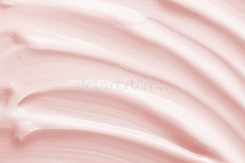 Beauty cream texture background. Pink color cosmetic cream lotion moisturizer smear