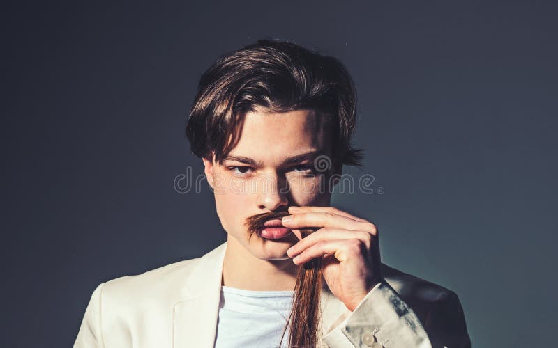 Beauty and fashion. Hair style and skincare. Man with trendy look. Fashion man with mystery look. Modern male stock image Beauty and fashion. Hair style and skincare. Man with trendy look. Fashion man with mystery look. Modern male stock image