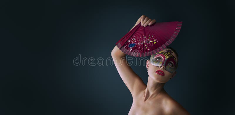 Woman wearing venetian masquerade carnival mask