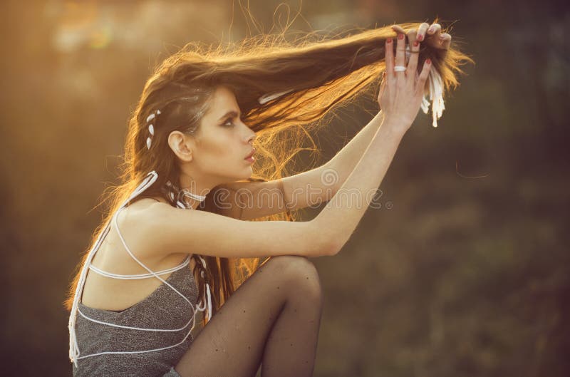 Beauty fashion portrait. girl with long fashionable indie hairstyle on natural background