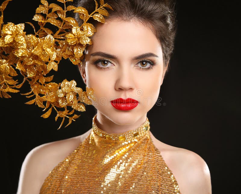 Beauty fashion woman in golden dress. Red lips. Glamour portrait of Beautiful sensual girl model on black background.