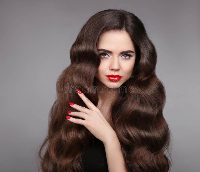 Beauty girl hair. Red lips and manicured nails. Beautiful model