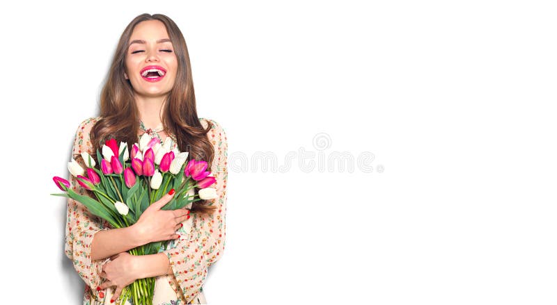 Beauty girl holding spring tulips. Happy beautiful woman receiving a bouquet of colorful tulips stock images Beauty girl holding spring tulips. Happy beautiful woman receiving a bouquet of colorful tulips stock images