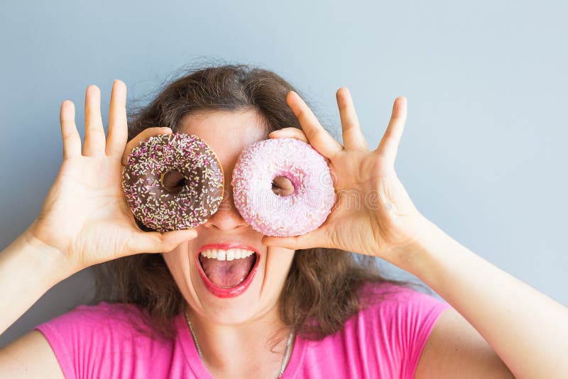 Beauty girl taking colorful donuts. Funny joyful woman with sweets, dessert. Diet, dieting concept. Junk food