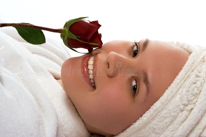 Beauty girl in towel with rose after shower