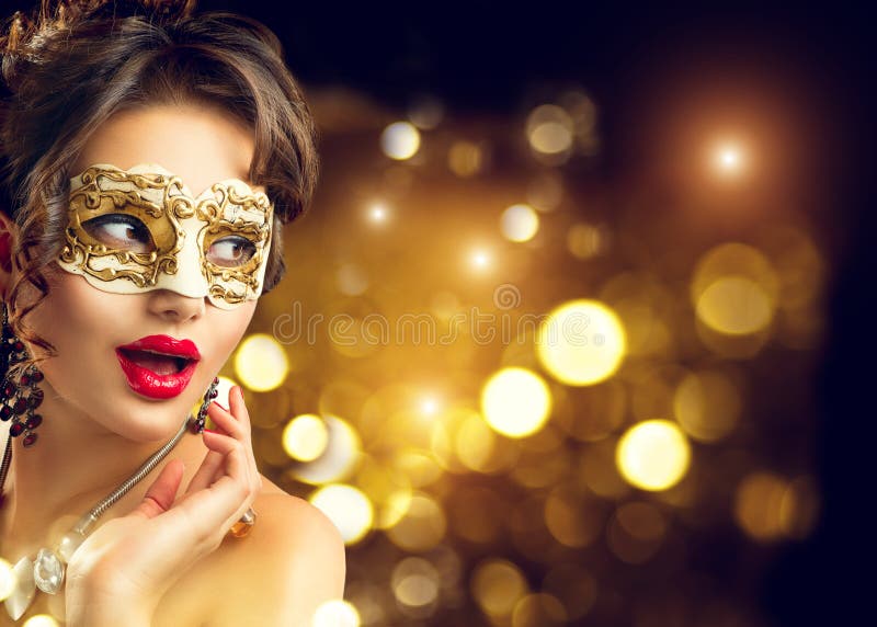 Beauty model woman wearing venetian masquerade carnival mask at party. Christmas and New Year celebration