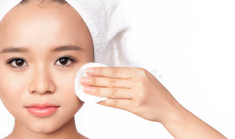 Beauty portrait of an Asian young woman cleaning the face with cotton stock photos Beauty portrait of an Asian young woman cleaning the face with cotton stock photos