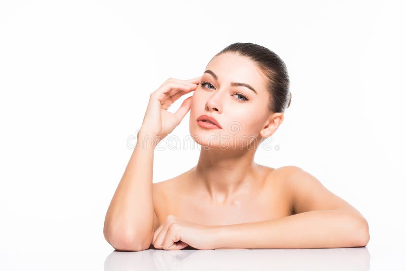 Beauty Portrait. Beautiful Spa Woman Touching her Face. Perfect Fresh Skin. Isolated on White Background. Pure Beauty