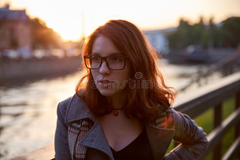 Beauty Romantic Girl Outdoors enjoying nature. Beautiful autumn red hair model with waving glow hair. Sun light on sunset. Warm co royalty free stock images Beauty Romantic Girl Outdoors enjoying nature. Beautiful autumn red hair model with waving glow hair. Sun light on sunset. Warm co royalty free stock images