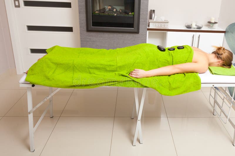 Beauty Salon Woman Getting Spa Hot Stone Therapy Massage Stock Image
