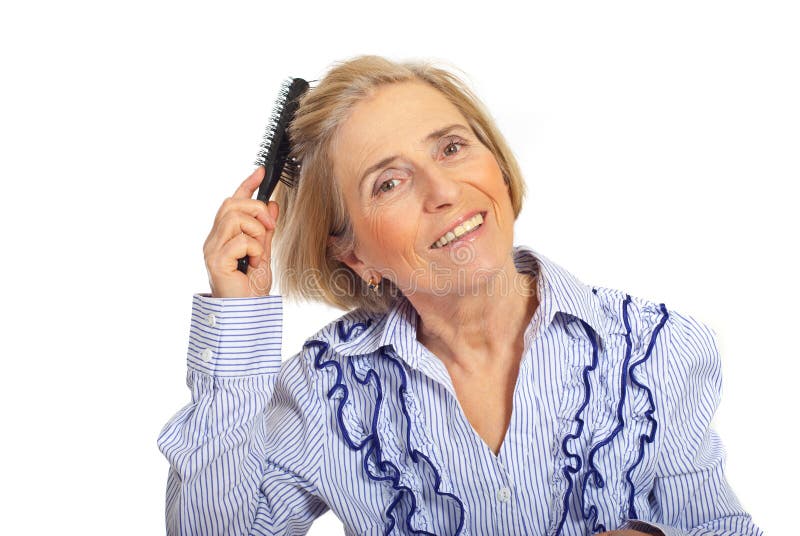 Beauty smiling blond senior woman brushing hair isolated on white background. Beauty smiling blond senior woman brushing hair isolated on white background