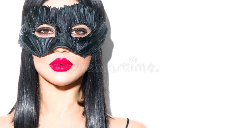 Beauty sexy Glamour brunette Woman portrait. Girl wearing carnival black feather mask. Party. Black hair, red lips, holiday makeup