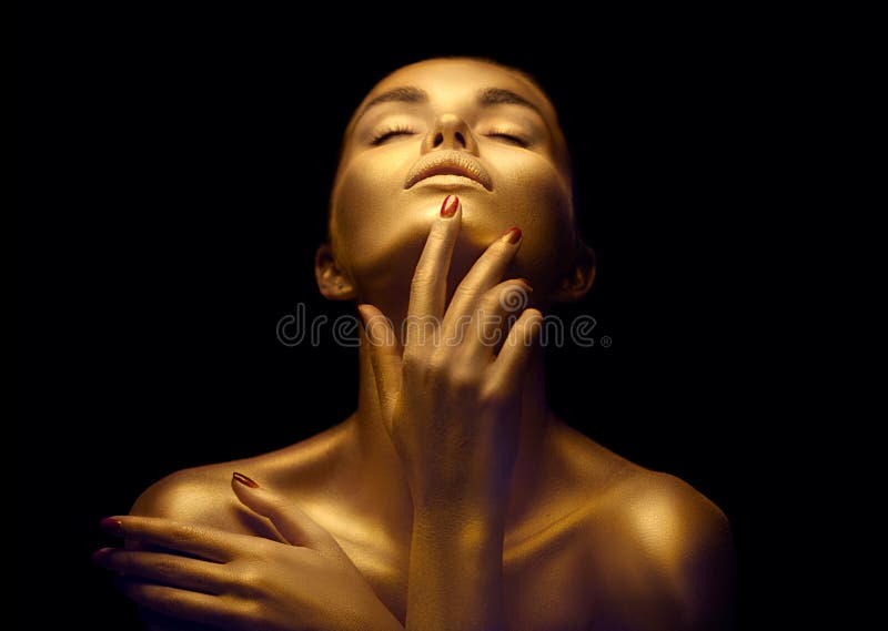 Beauty sexy woman with golden skin. Fashion art portrait closeup. Model girl with shiny golden professional makeup