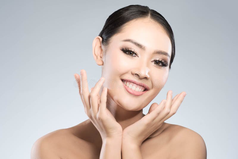 Beauty shot of young pretty asian woman with clear skin ongrey b