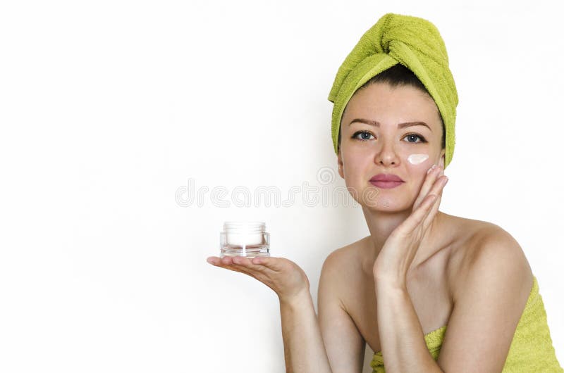 Beauty and skin care concept. close up portrait young, beautiful, attractive woman applies cosmetic product, moisturizing cream royalty free stock photos Beauty and skin care concept. close up portrait young, beautiful, attractive woman applies cosmetic product, moisturizing cream royalty free stock photos