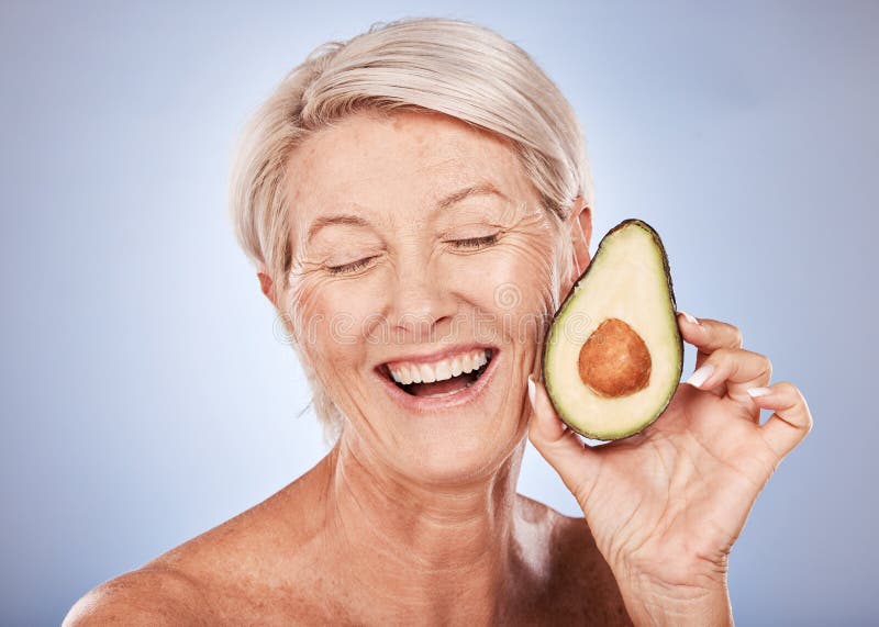 Beauty, skincare and elderly woman with avocado cosmetics smile for organic skin health, natural detox and luxury spa