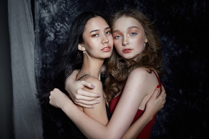 Beauty Spring Portrait Of Two Girls On A Dark Background Women Hug And